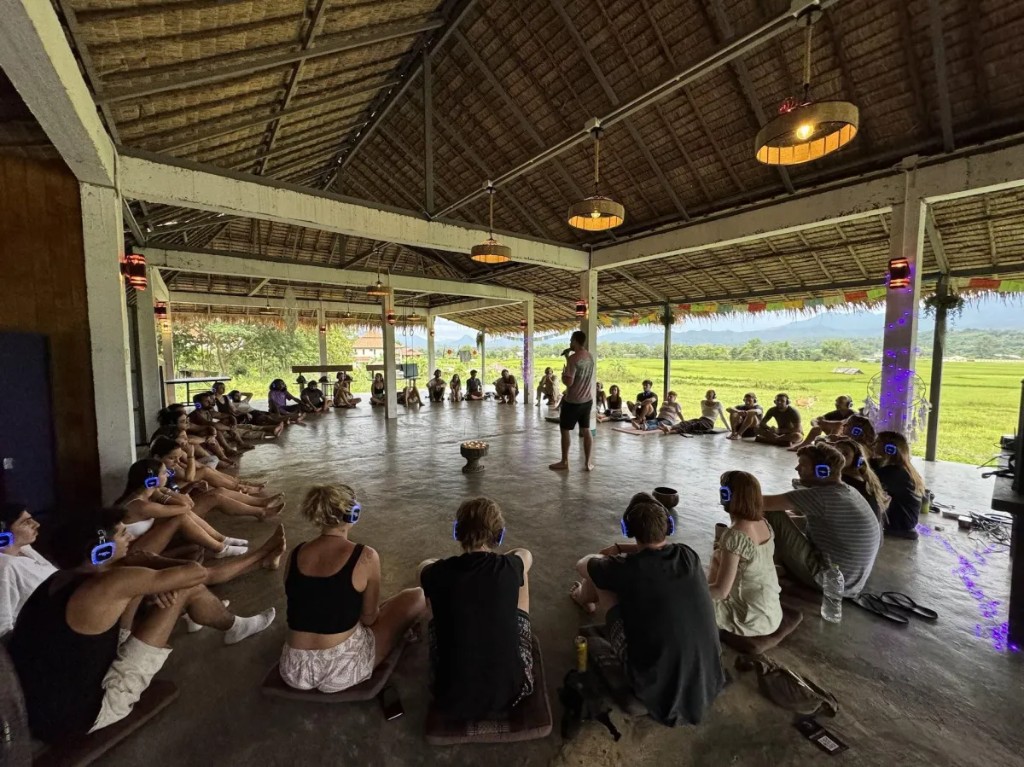 Barak Yaari facilitating a hypnosis session for a seated room.
